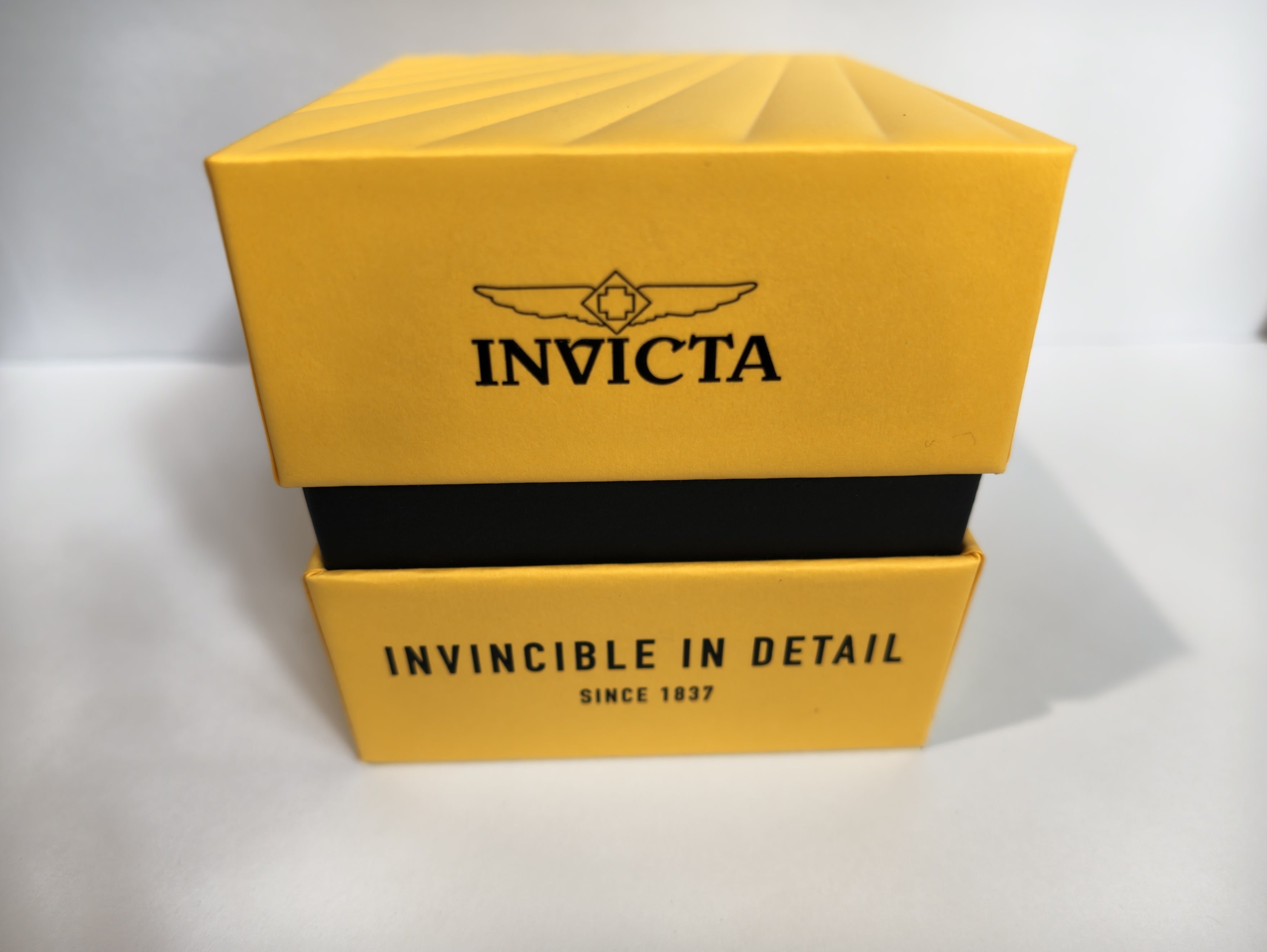 Invicta Pro Diver watch inside original box, overhead view with tag