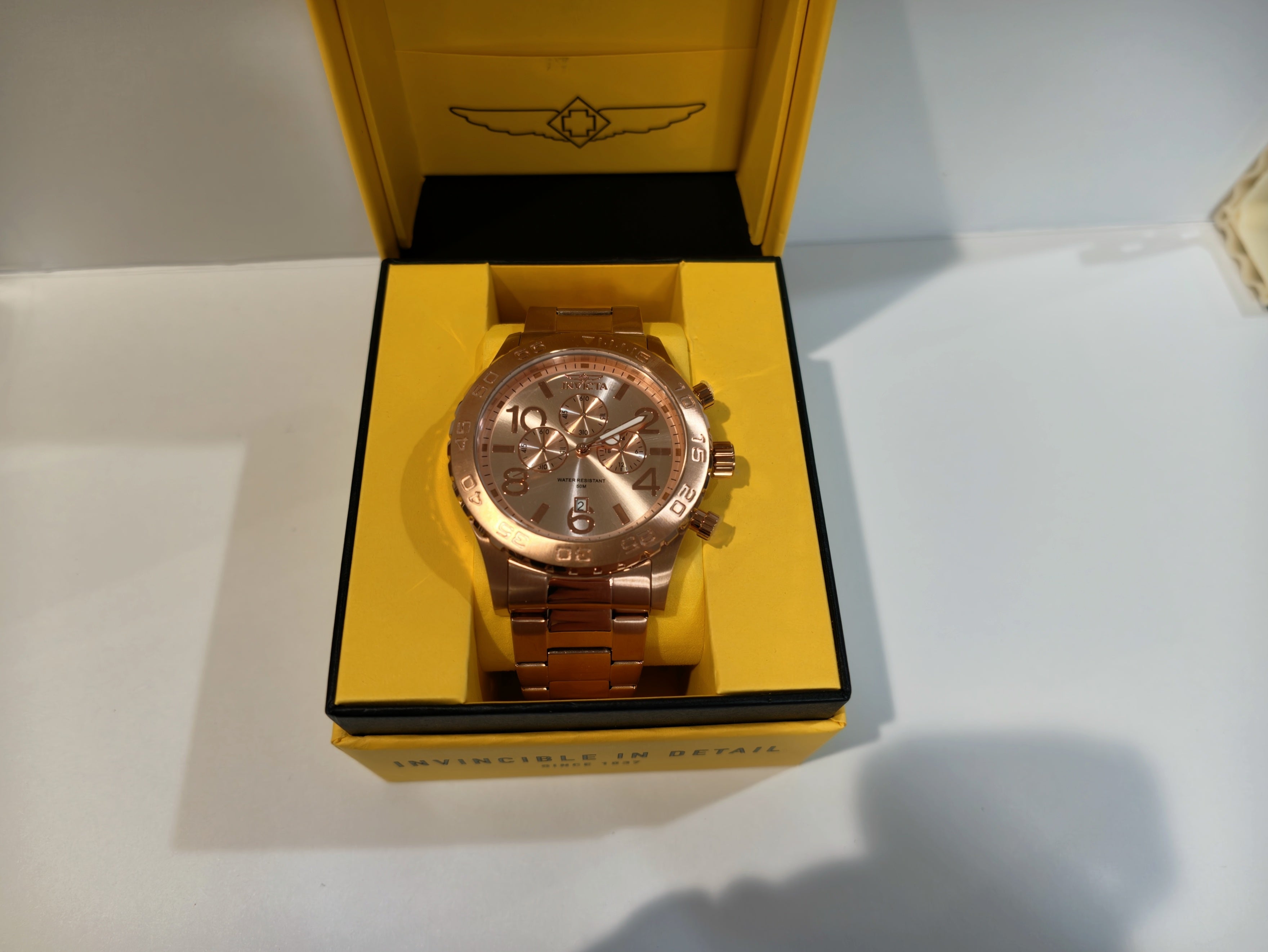 Invicta chronograph watch in Invicta branded packaging, top view