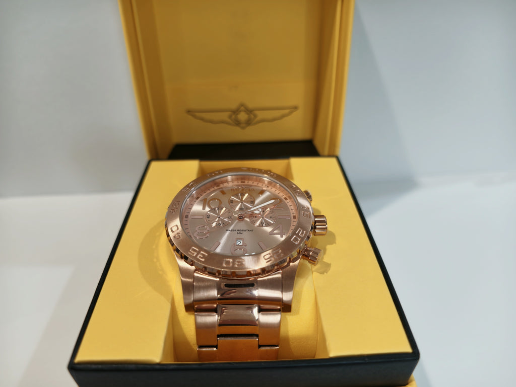 Invicta rose gold watch displayed inside original yellow gift box