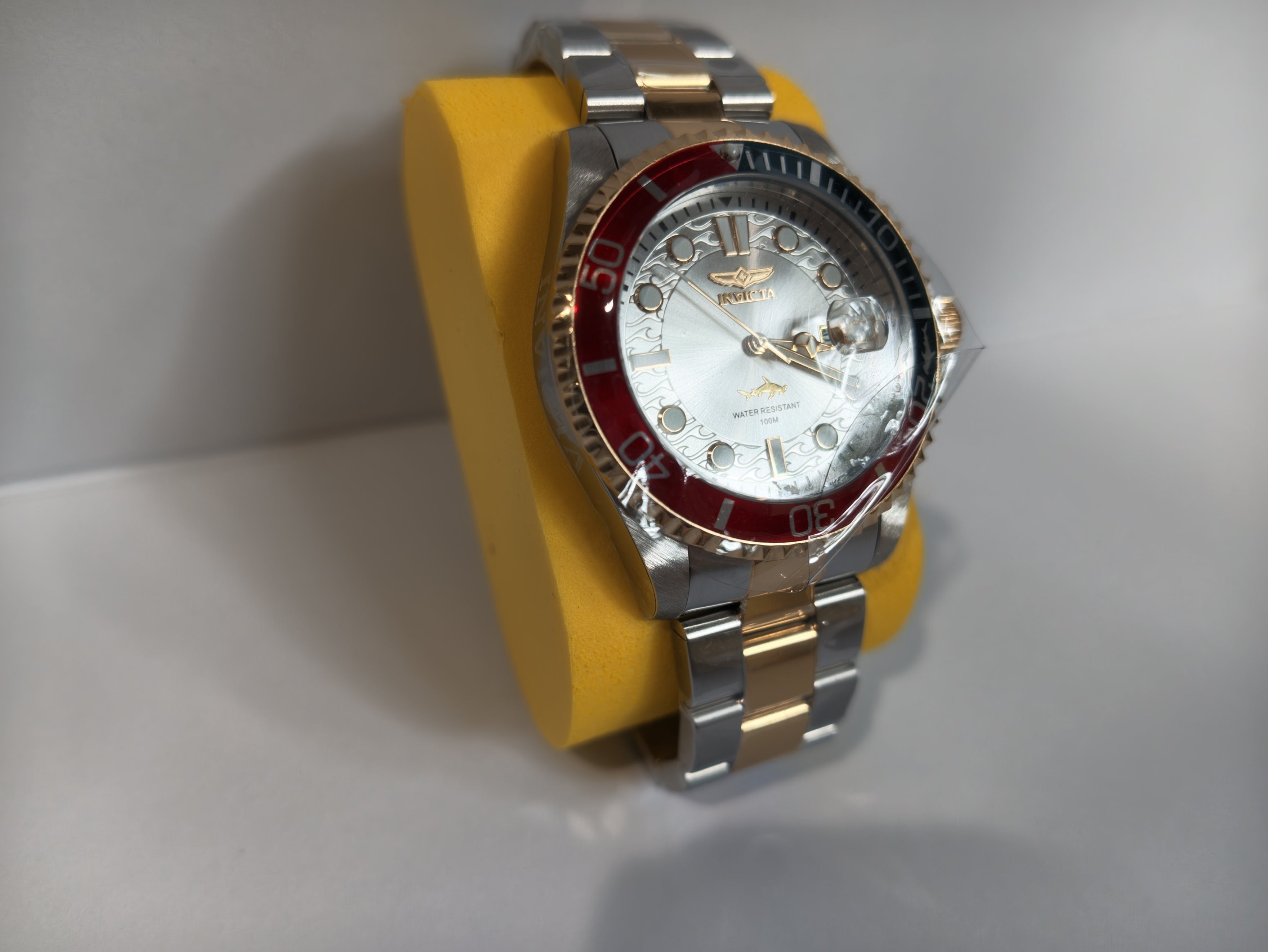 Invicta Pro Diver rose gold and silver watch angled side view
