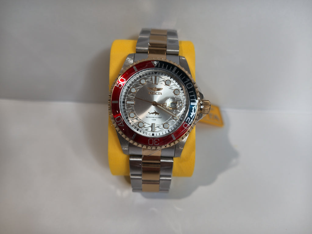	Invicta Pro Diver two-tone watch with red and blue bezel on display stand
