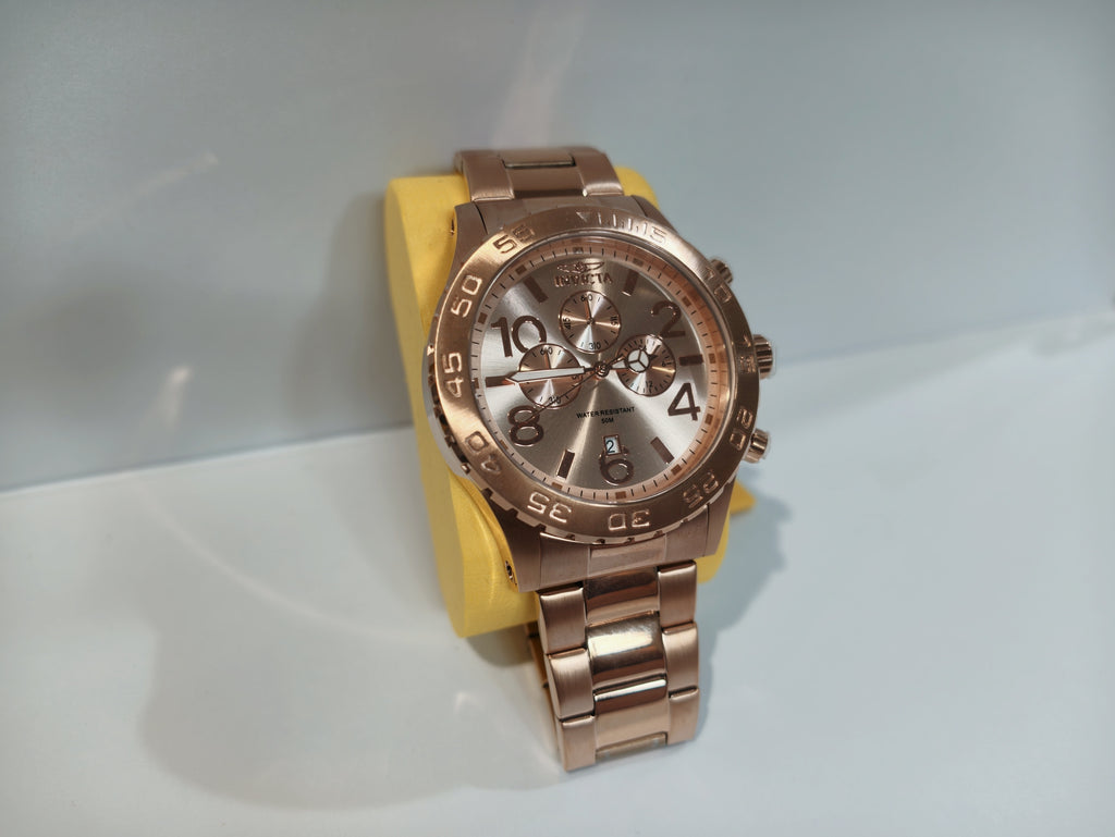 Invicta rose gold watch face detail with tachymeter bezel and crown
