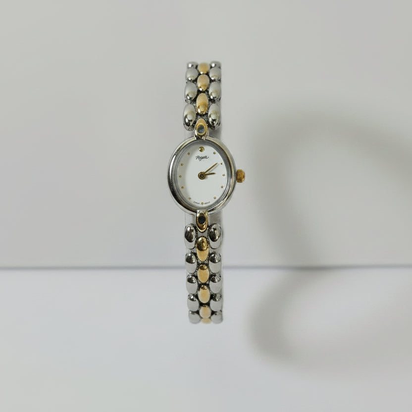 Front view Swiss Made women's watch white dial with ruby red gemstone connectors and two-tone bracelet