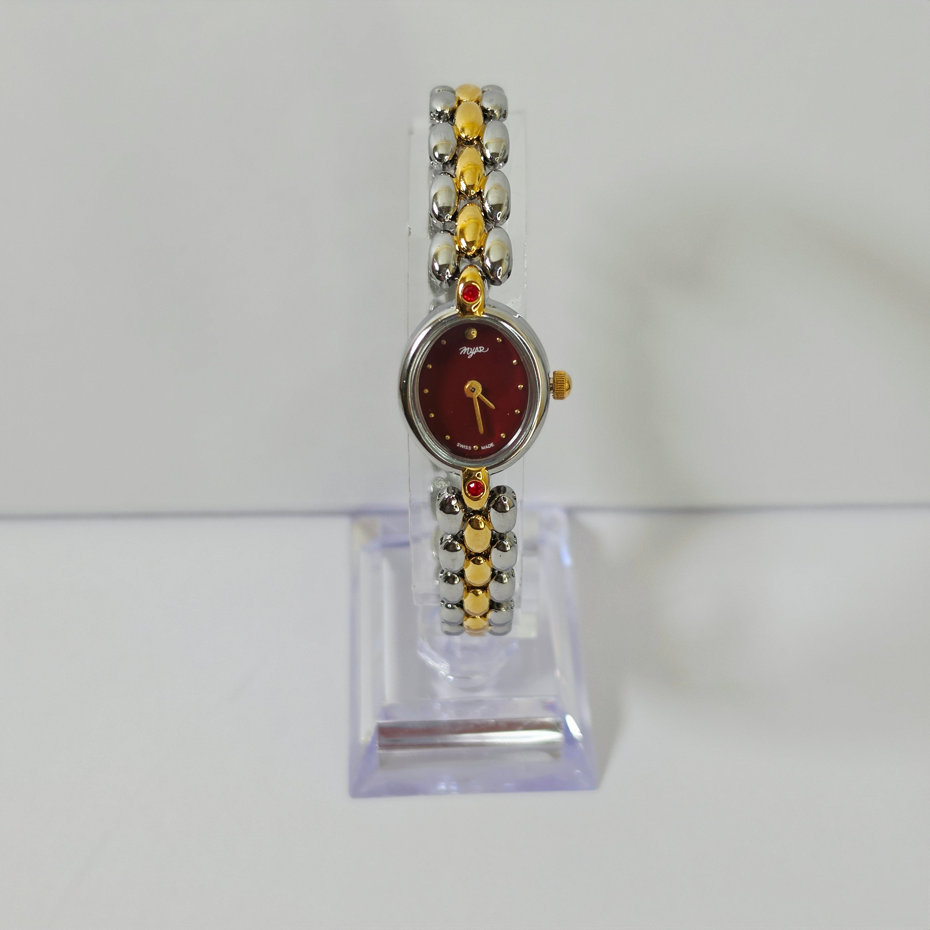 Burgundy red dial Swiss Made women's oval watch with ruby gemstones and gold silver bracelet