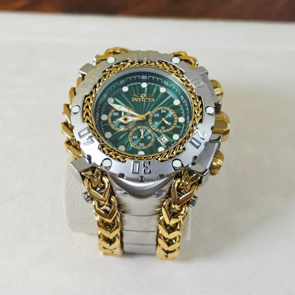 An Invicta men's watch featuring a two-tone silver and gold-tone case, a green dial with gold accents, and a matching gold and silver chain link bracelet, displayed on a white stand.