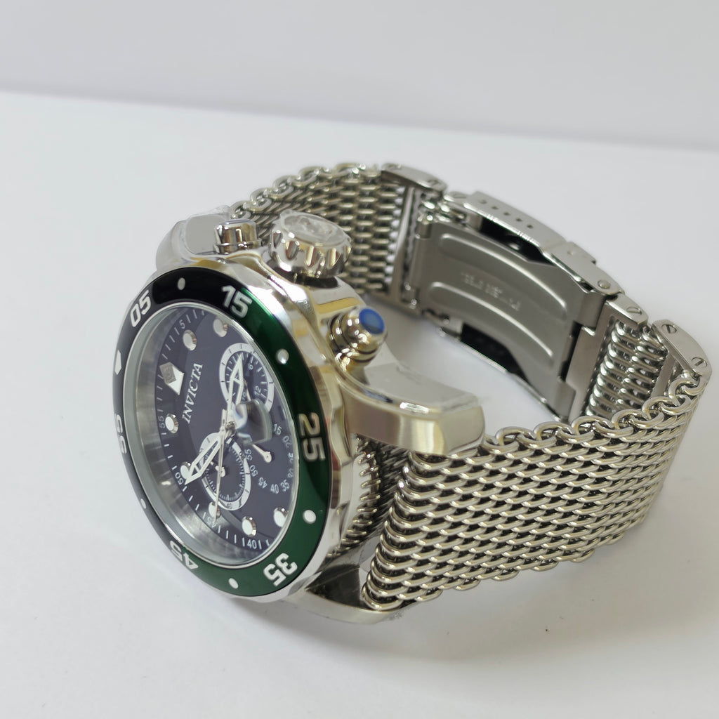 A stainless steel analog watch with a silver mesh bracelet, a dark blue dial, a green bezel, and white chronograph details, photographed on a white background.
