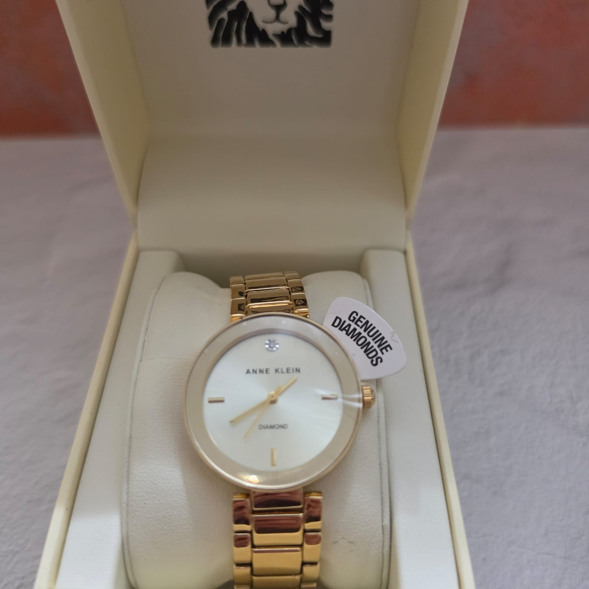 Anne Klein gold tone diamond accent watch with white mother of pearl n original box