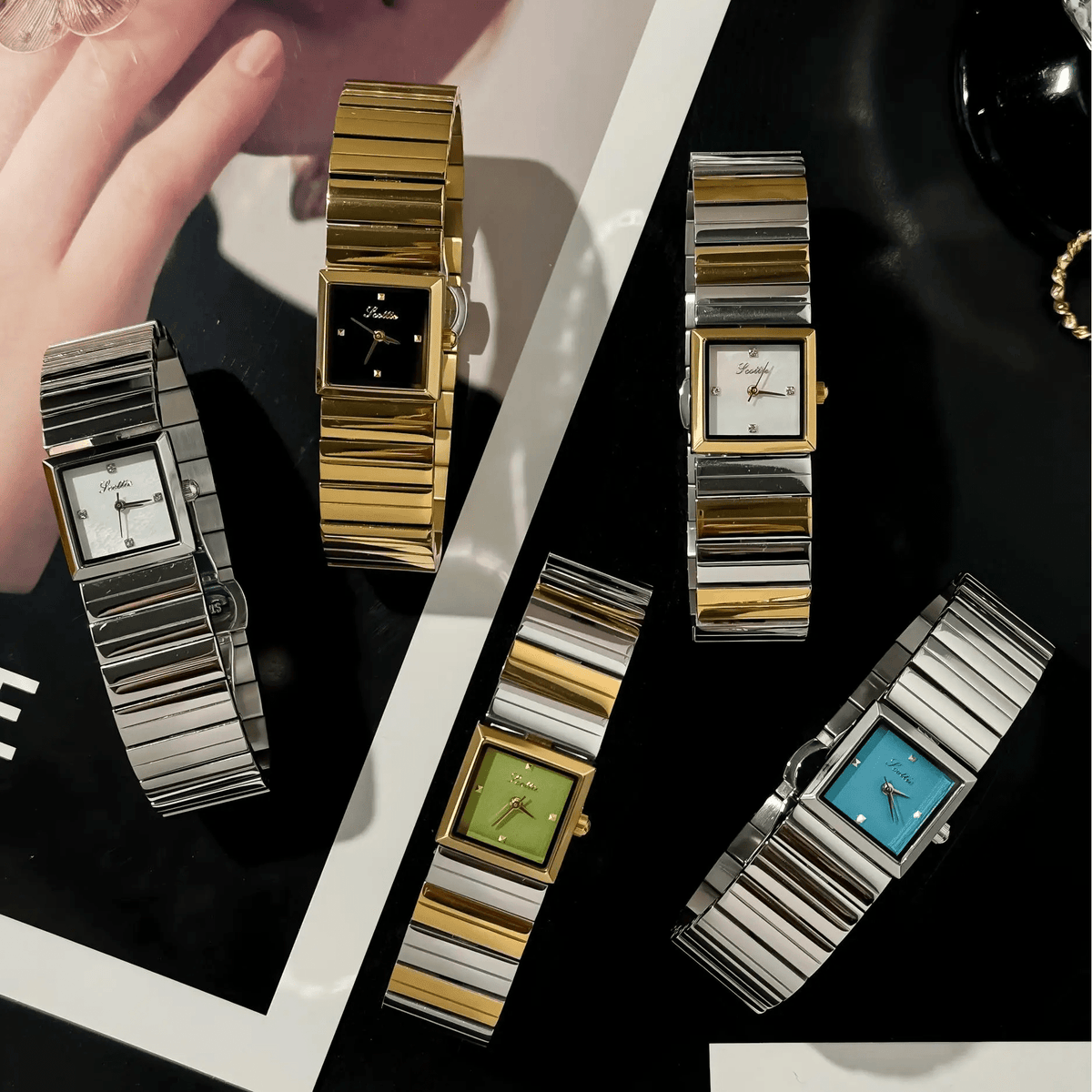 Flat lay of square bracelet watch collection in gold and silver tones, multiple dial colors
