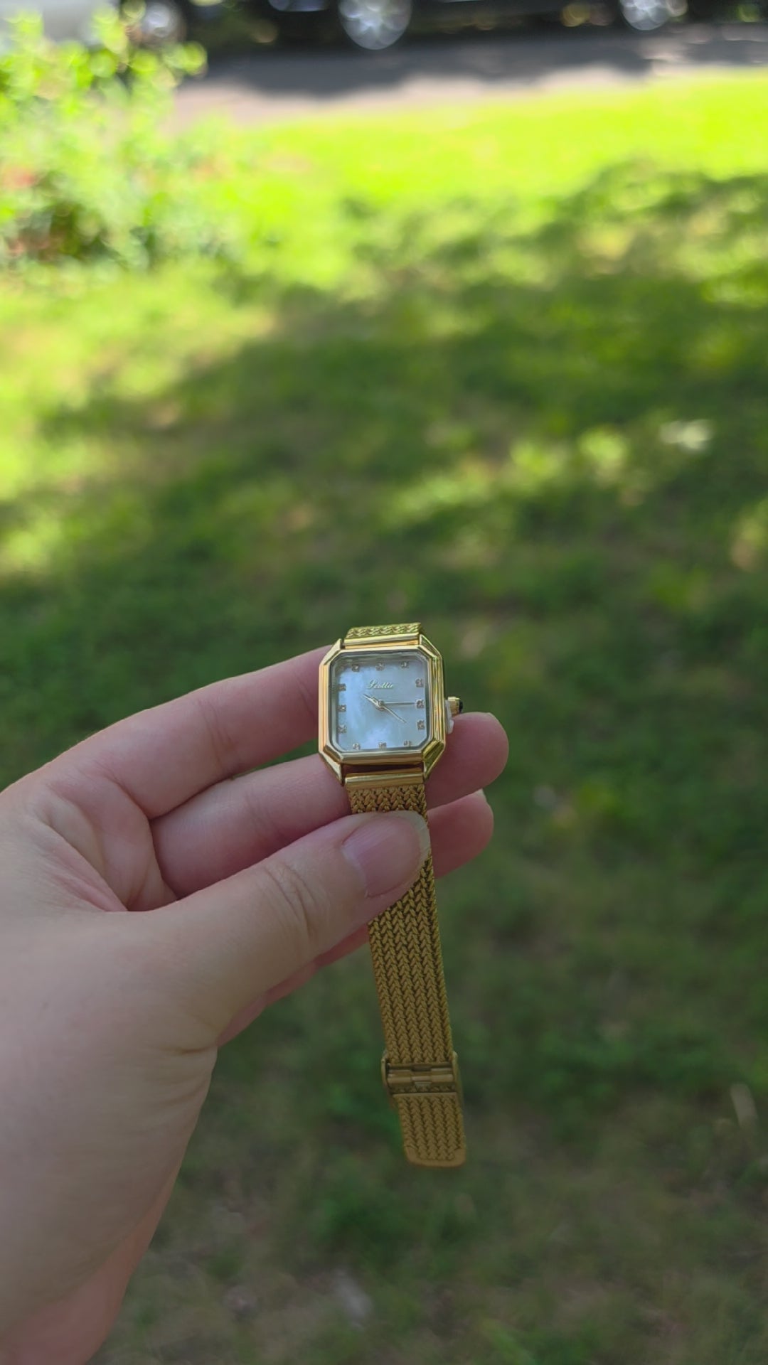 Front view womens gold square watch with white dial and woven mesh bracelet